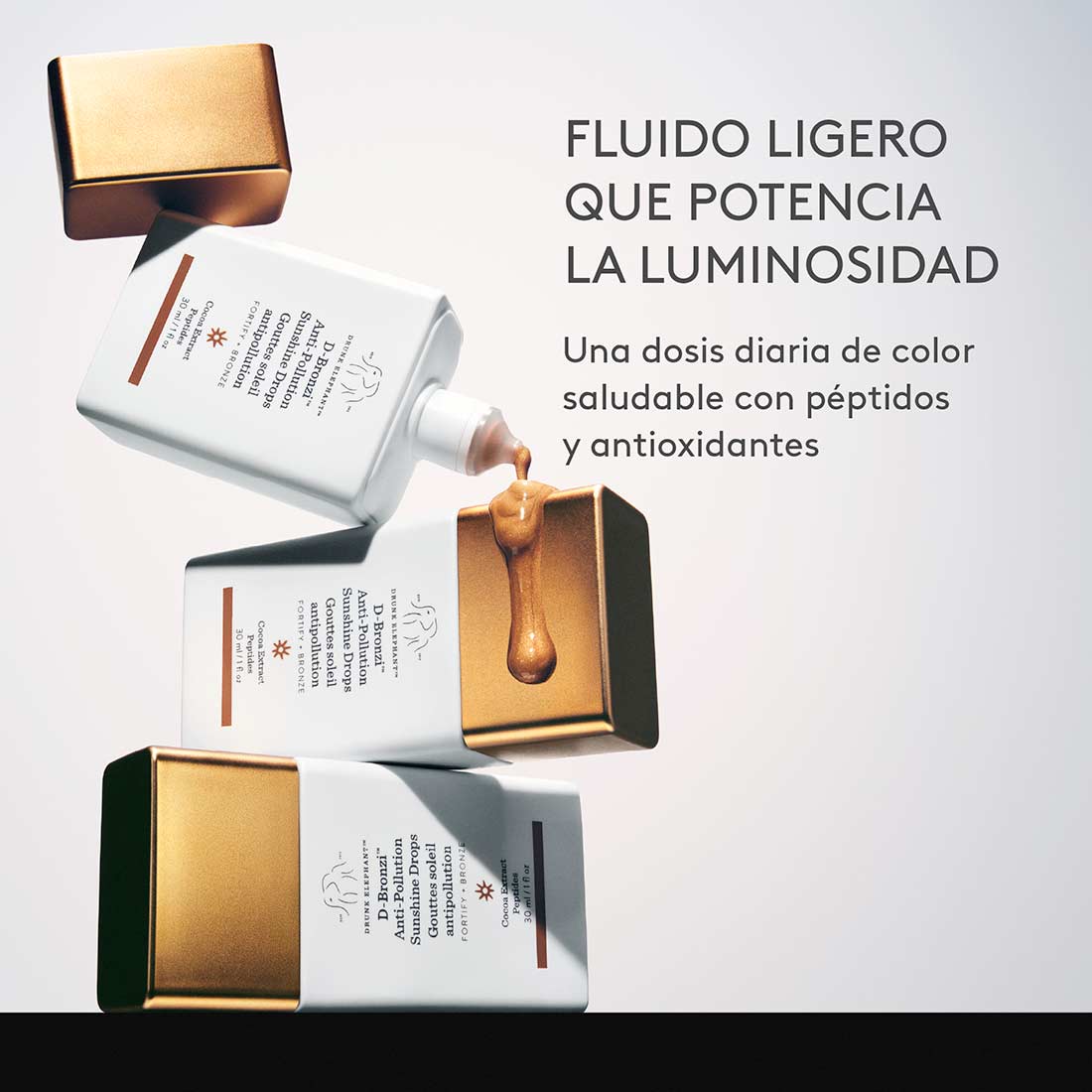 Gotas D-Bronzi de Drunk Elephant cayendo desde el frasco, fluido ligero que potencia la luminosidad