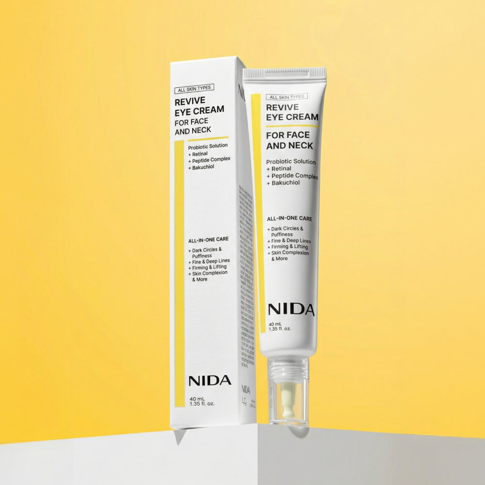 NIDA Revive Eye Cream con su caja sobre fondo amarillo — Glowup Makeup